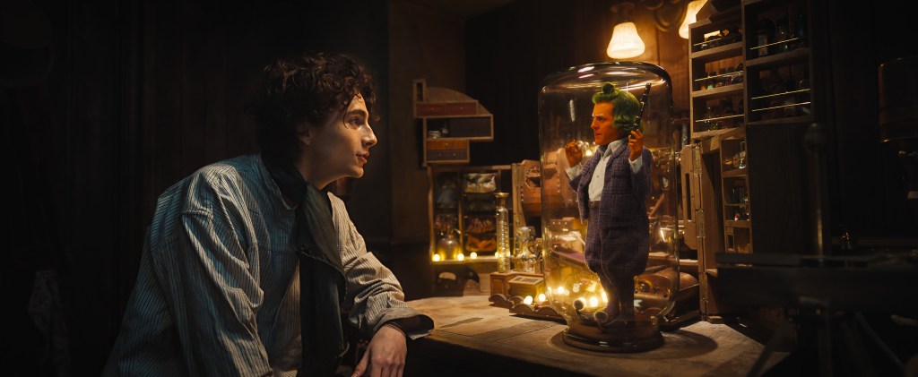 TIMOTHÉE CHALAMET as Willy Wonka and HUGH GRANT as an Oompa Loompa in Warner Bros. Pictures and Village Roadshow Pictures’ “WONKA,” a Warner Bros. Pictures release.